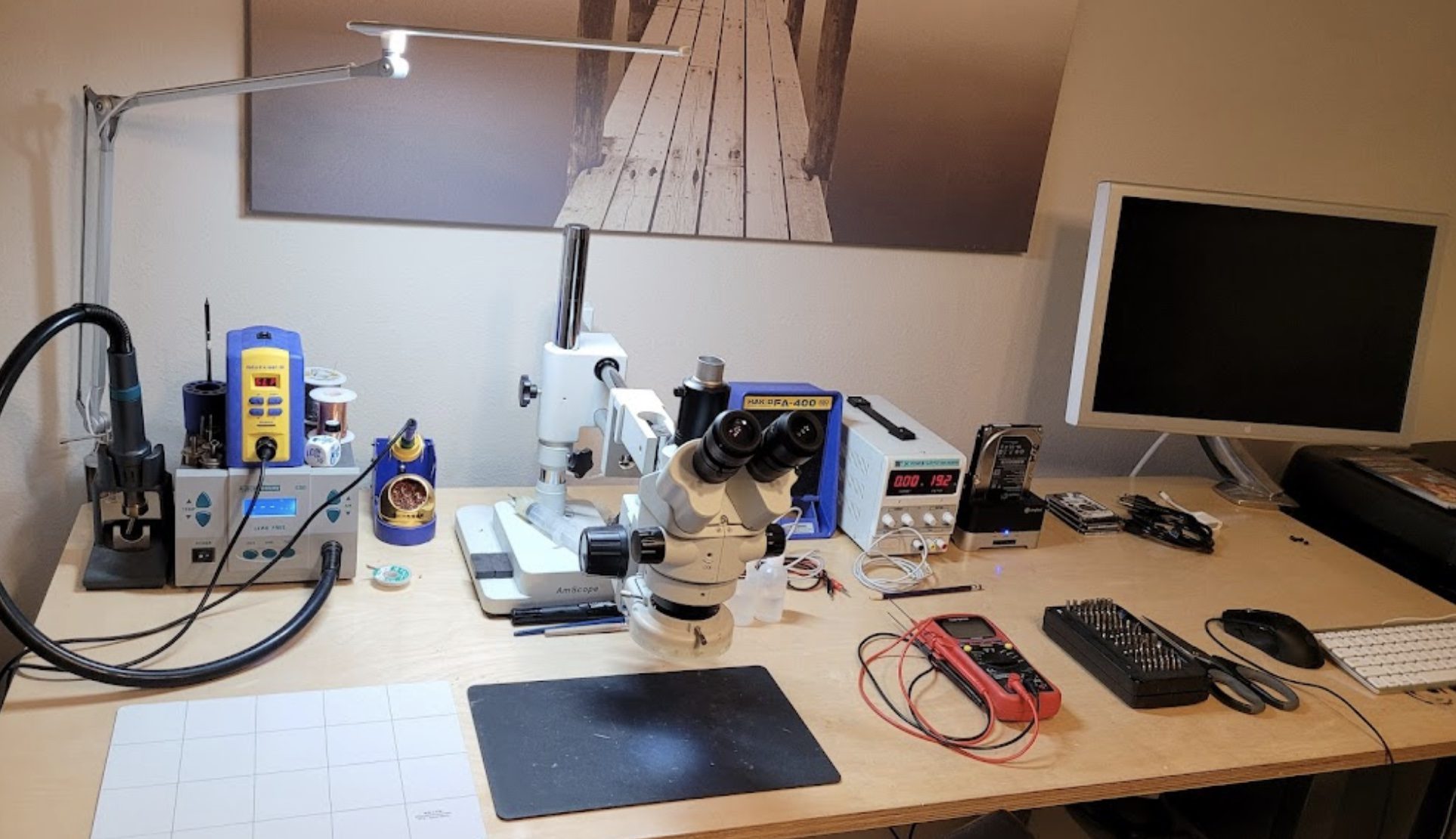Micro-soldering workbench with microscope, soldering station, and diagnostic equipment